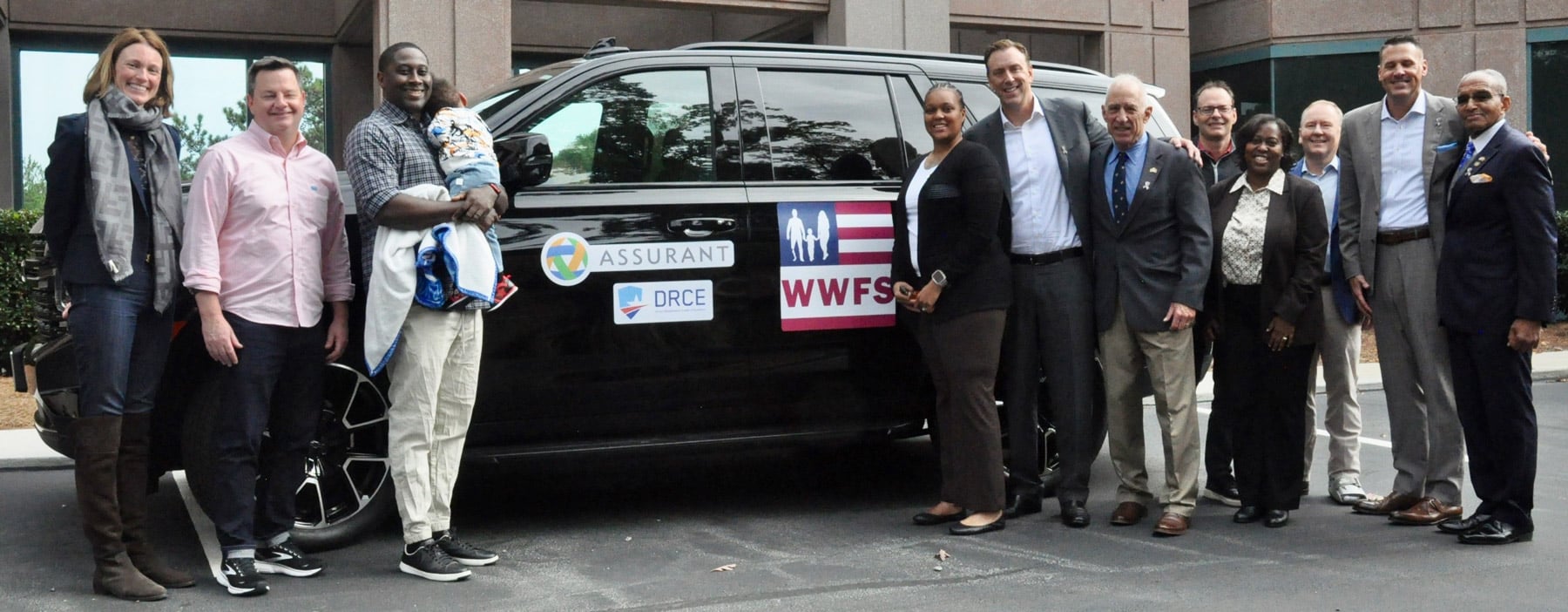 WWFS and ASSURANT leadership teams present new Modified Chevy Tahoe to Army Veteran Stephanie Johnson